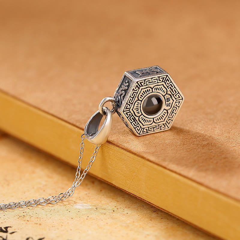 Om Mani Padme Hum Pendant – Antiqued silver hexagonal necklace with engraved trigram symbols on parchment