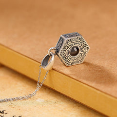 Om Mani Padme Hum Pendant – Antiqued silver hexagonal necklace with engraved trigram symbols on parchment