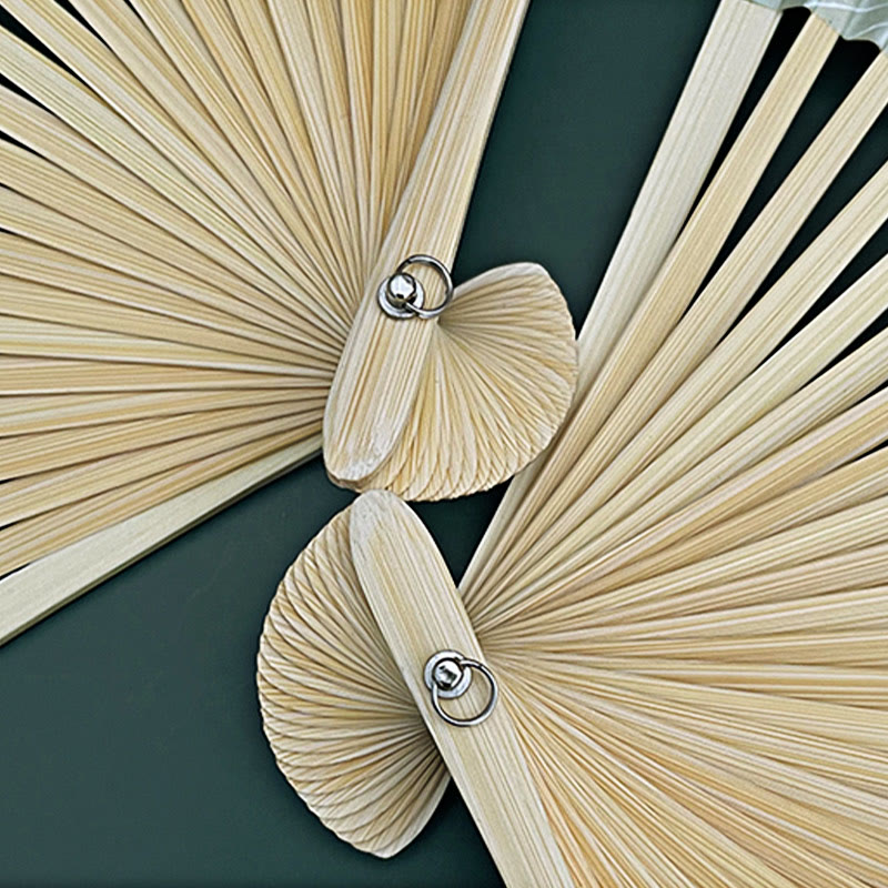 Lotus Koi Fish Folding Fan - folded pair revealing bamboo ribs and metal pivot hardware, craft