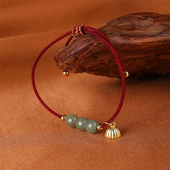 Hetian Jade Lotus Pod Braided Bracelet – jade beads with gold lotus pod charm on driftwood, artisan