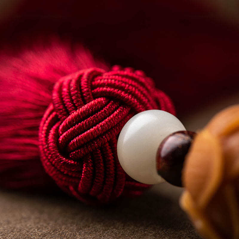 Red Sandalwood Car Hanging – Macro detail of braided burgundy cord with dark wood beads, red string bracelet texture