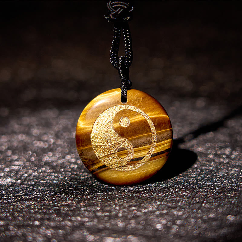 Yin Yang Crystal Necklace – Polished tiger eye pendant with gold yin-yang symbol, natural golden-brown striped chatoyant lust