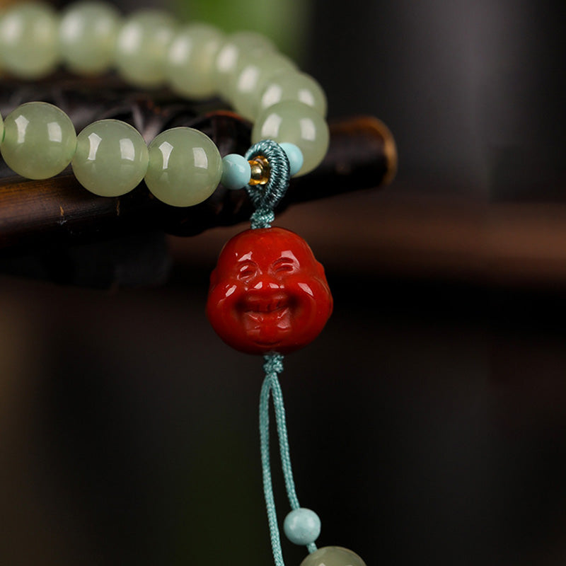 Amber Jade Laughing Buddha Bracelet - Flat lay with gift packaging, prosperity spiritual gift set