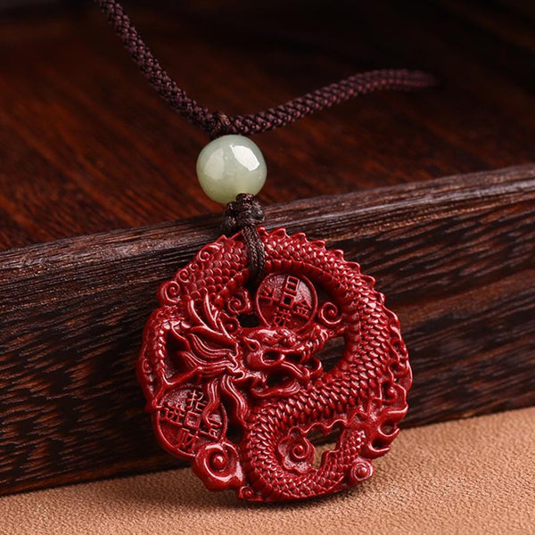 Cinnabar Hetian Jade Dragon Necklace - dragon pendant with prosperity symbols on rustic wood
