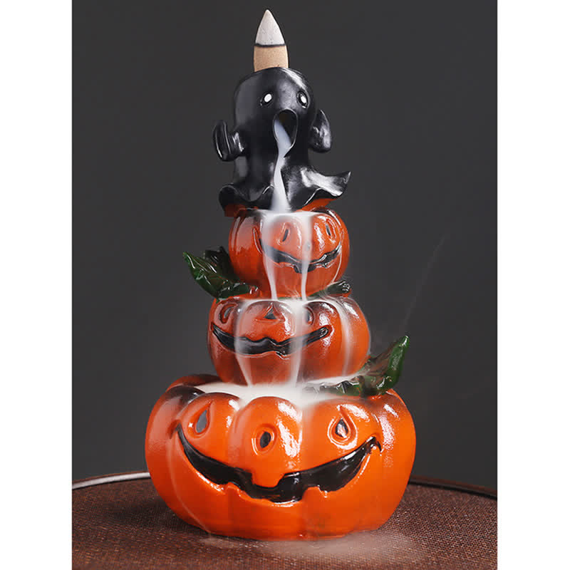 Triple pumpkin ghost backflow incense burner, white smoke waterfall through jack-o-lantern faces, dark gray background – backflow incense holder