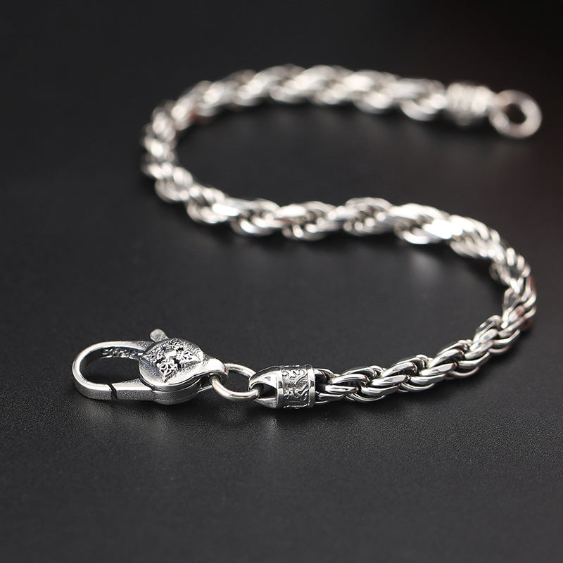 Silver Wheat Chain Bracelet – braided spiga chain with lion-head clasp, dark background, men's bracelet
