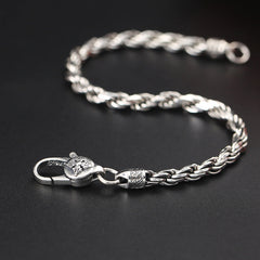 Silver Wheat Chain Bracelet – braided spiga chain with lion-head clasp, dark background, men's bracelet