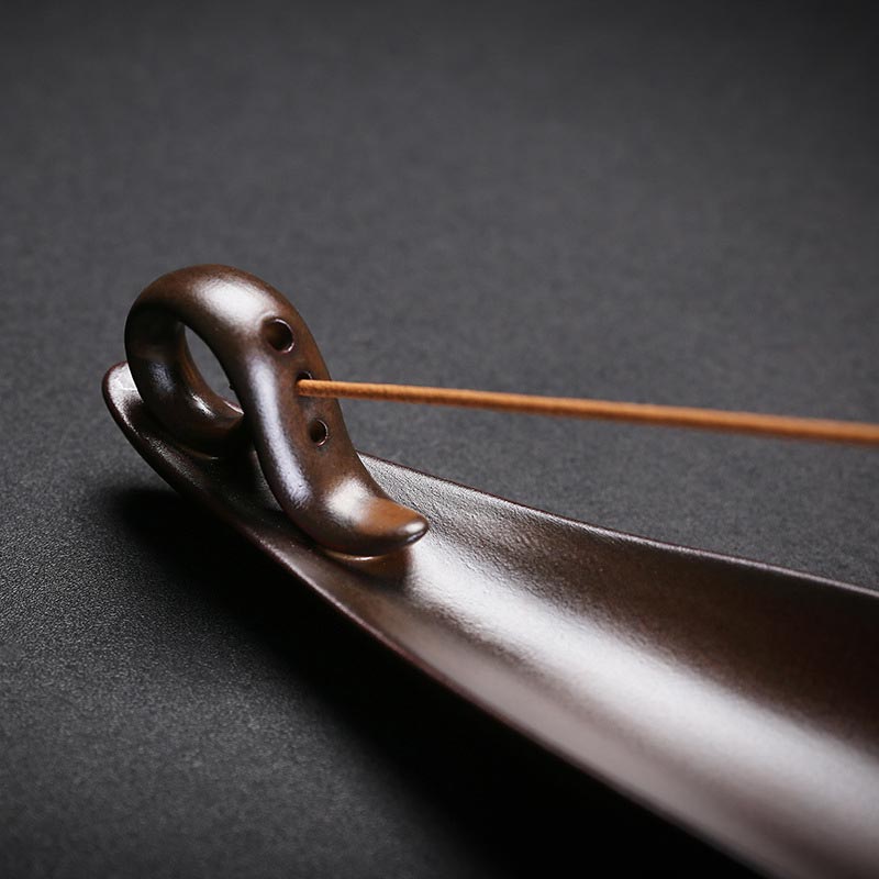 Ceramic Incense Burner – Dark brown holder with curved support and unlit stick, Minimalist