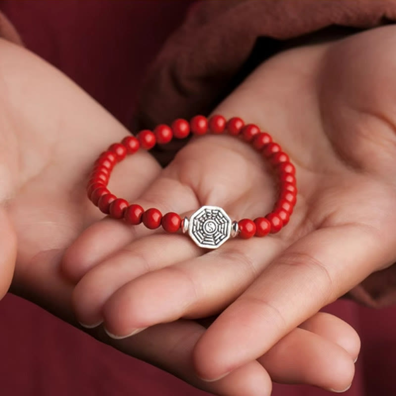 925 Sterling Silver Yin Yang Bagua Cinnabar Bracelet – Red beaded bracelet held in cupped hands, burgundy gift presentation