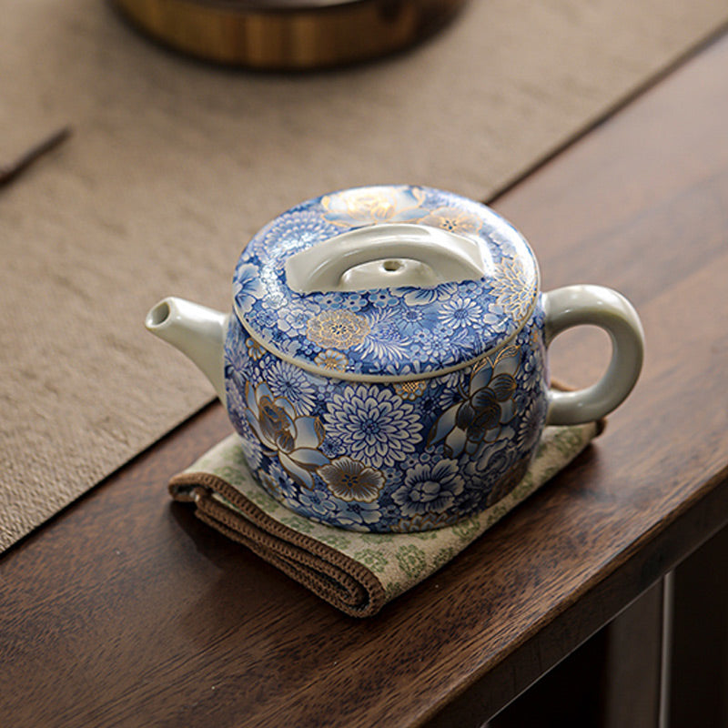Lotus Chrysanthemum Ceramic Teapot - Lidded blue-white teapot with gold blooms on fabric, traditional