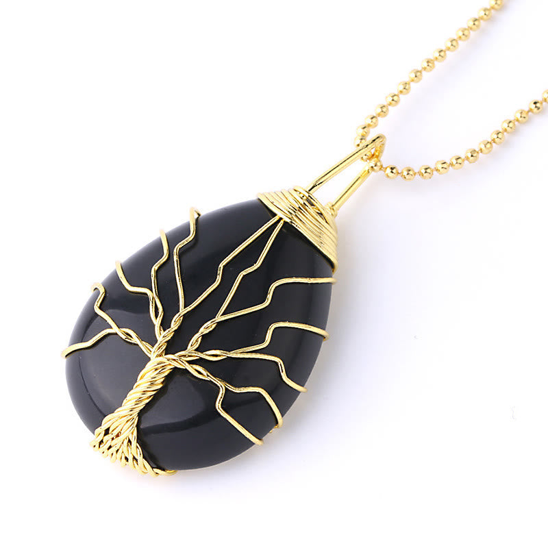 Quartz Crystal Tree of Life Necklace – black onyx teardrop pendant, gold wire tree, three-quarter, protection