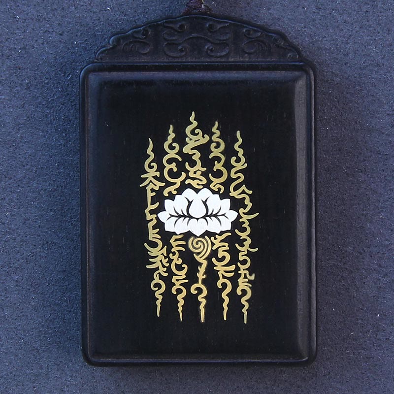 Ebony Wood Lotus Pendant – Close-up lotus and gold script on black stone, Zen