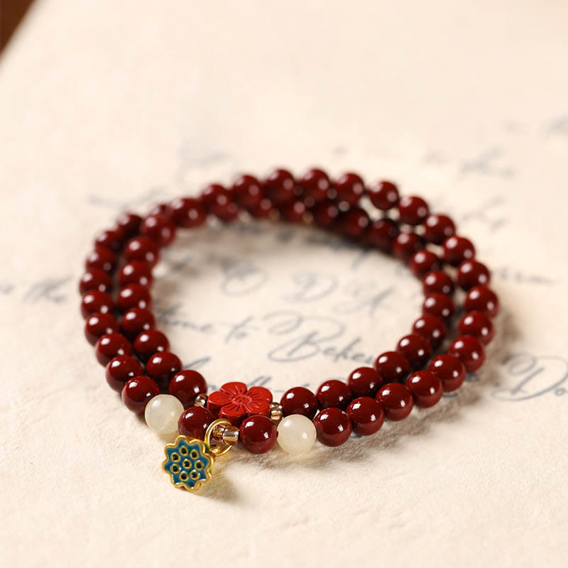 Cinnabar Lotus Bracelet – double strand on vintage paper with enamel pendant, beaded bracelet
