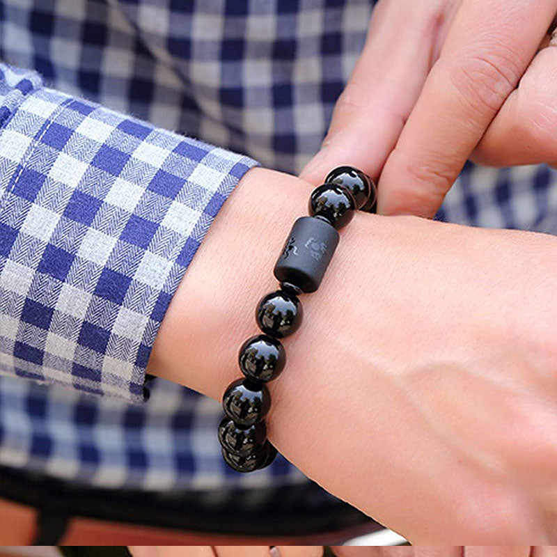 Black Obsidian Phoenix Dragon Bracelet – Worn on wrist with engraved barrel bead, casual style