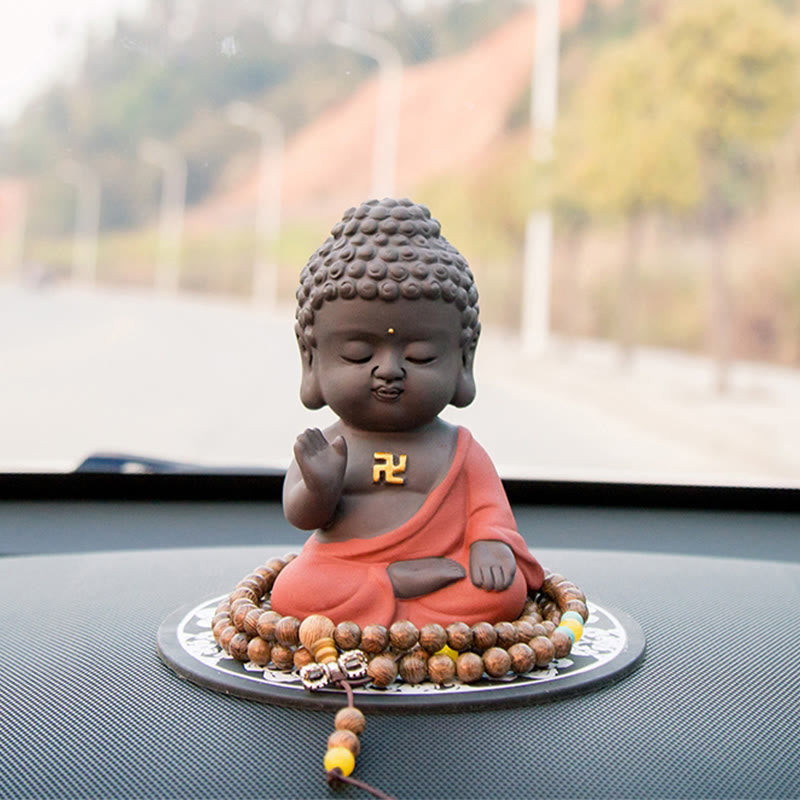 Small Buddha Purple Clay Decoration – frontal car dashboard shot with prayer beads and autumn bokeh, vehicle talisman, Safe J