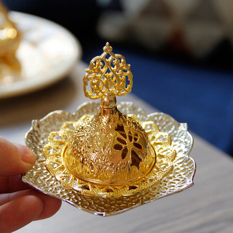 Gold Leaf Coaster Incense Burner with hand holding base, active smoke, filigree dome, alloy incense burner