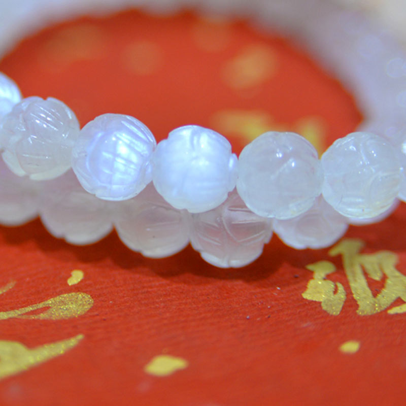 Natural Moonstone Lotus Love Bracelet - extreme close-up on red gold, carved bead detail