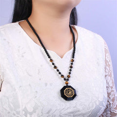Black Obsidian Tiger Eye Bagua Yin Yang Pendant - Bagua necklace worn on model with lace top, spiritual protection jewelry