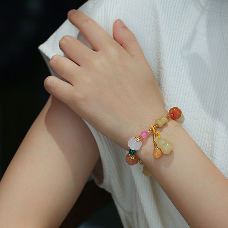 Golden Silk Jade Gourd Bracelet – Wrist styling shot with white fabric background