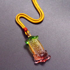 Buddha Liuli Lotus Necklace – pendant glowing under light with blue green iridescence, sacred charm