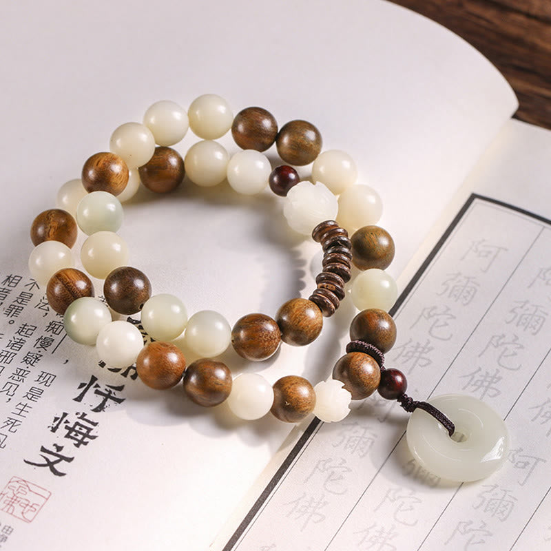Bodhi Seed Sandalwood Lotus Bracelet - jade and wood beads with peace buckle on scripture page, serene