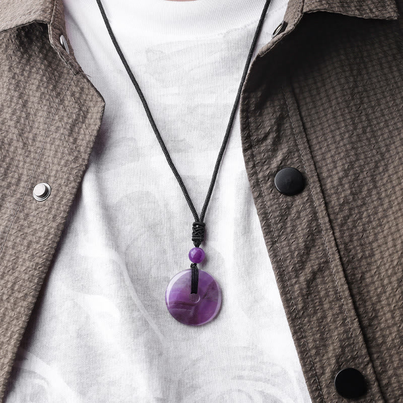 Lucky Coin Pendant Healing Crystal Gemstone Necklace – Purple amethyst peace buckle necklace worn over white shirt and brown jacket