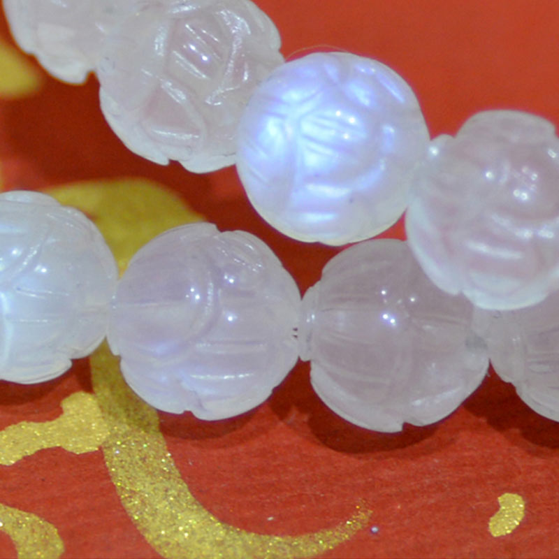 Natural Moonstone Lotus Love Bracelet - macro close-up on red ceremonial cloth, cultural jewelry