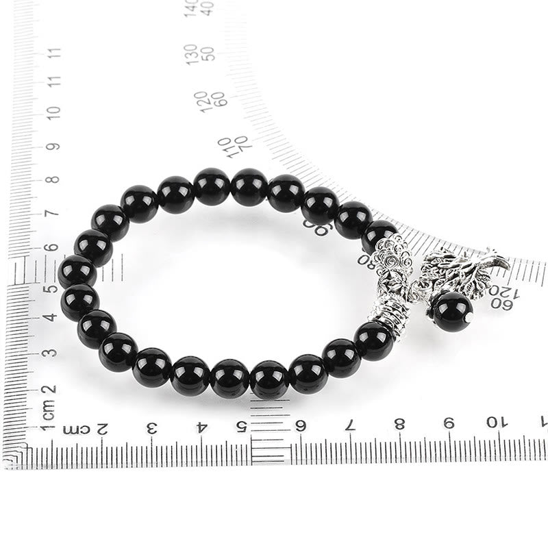 Tree of Life black onyx bracelet with shiny black agate beads, silver tree charm, displayed with measurement rulers for size reference.