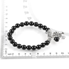 Tree of Life black onyx bracelet with shiny black agate beads, silver tree charm, displayed with measurement rulers for size reference.