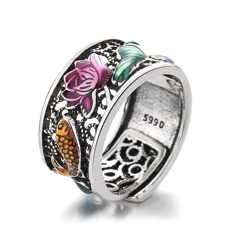 Copper Enamel Koi Fish Ring – natural outdoor lighting with bokeh greenery in background