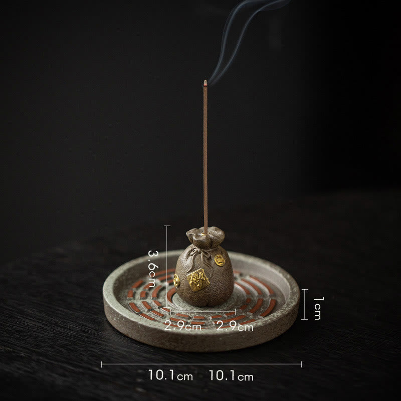 Triple Money Bag Incense Burner – Three colorful fortune pouches on bagua ceramic base, burning incense