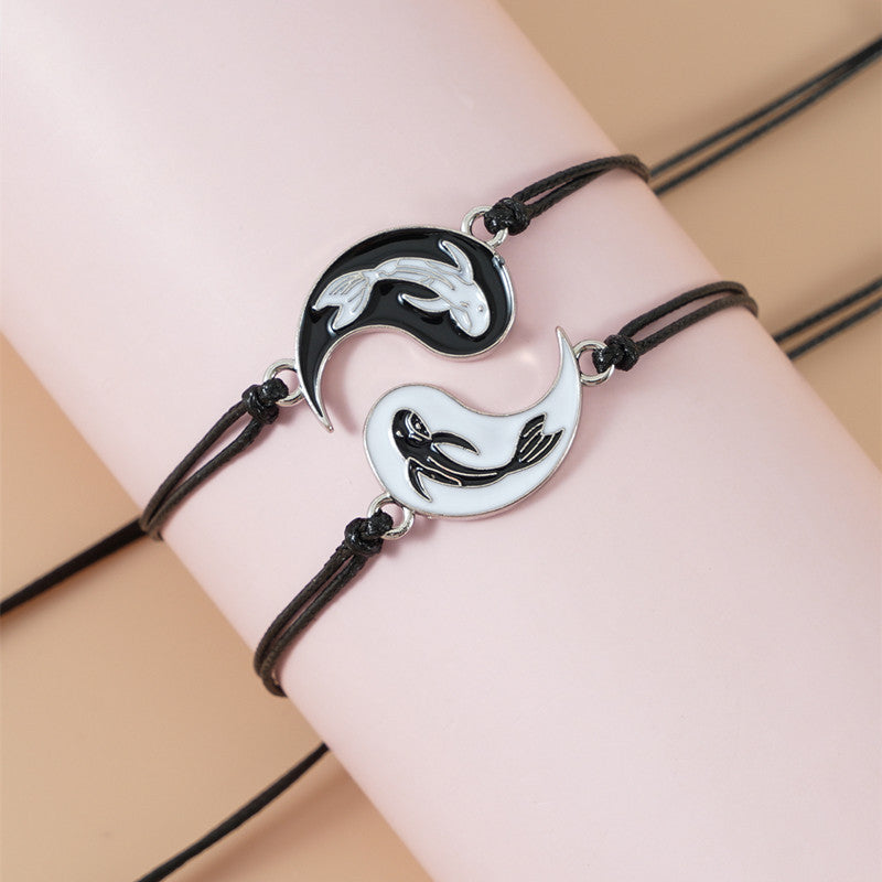 Yin Yang Hematite Bracelet - Mermaid silhouette pair on pink display form, adjustable black cords
