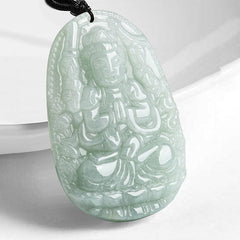 Zodiac Buddha Jade Necklace – carved guardian deity jade pendant on black cord, white studio display, spiritual amulet