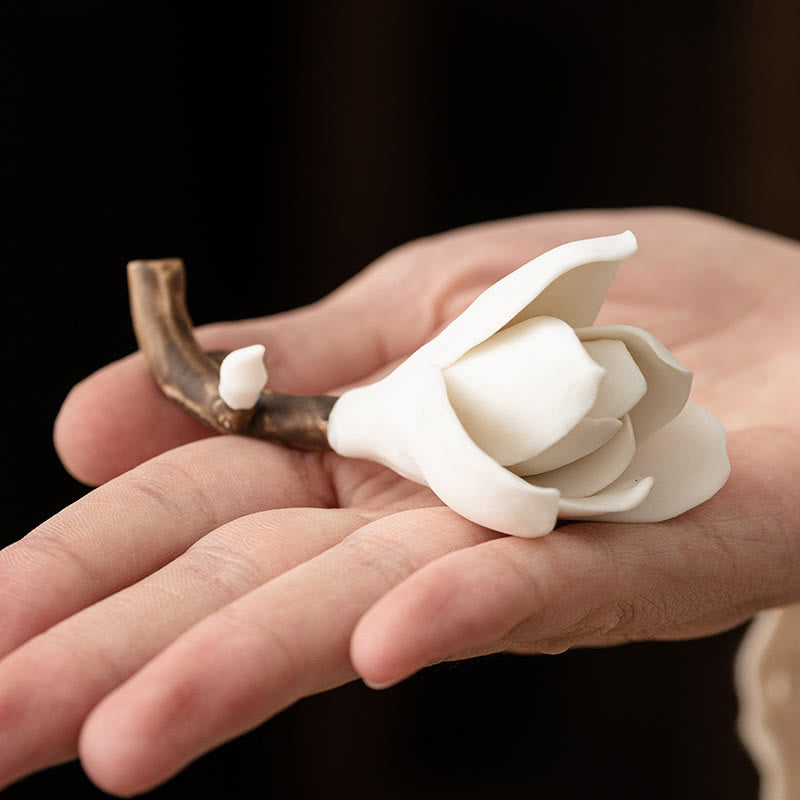 Gardenia Ceramic Incense Burner – White magnolia on branch held in palm, small bud detail, black background