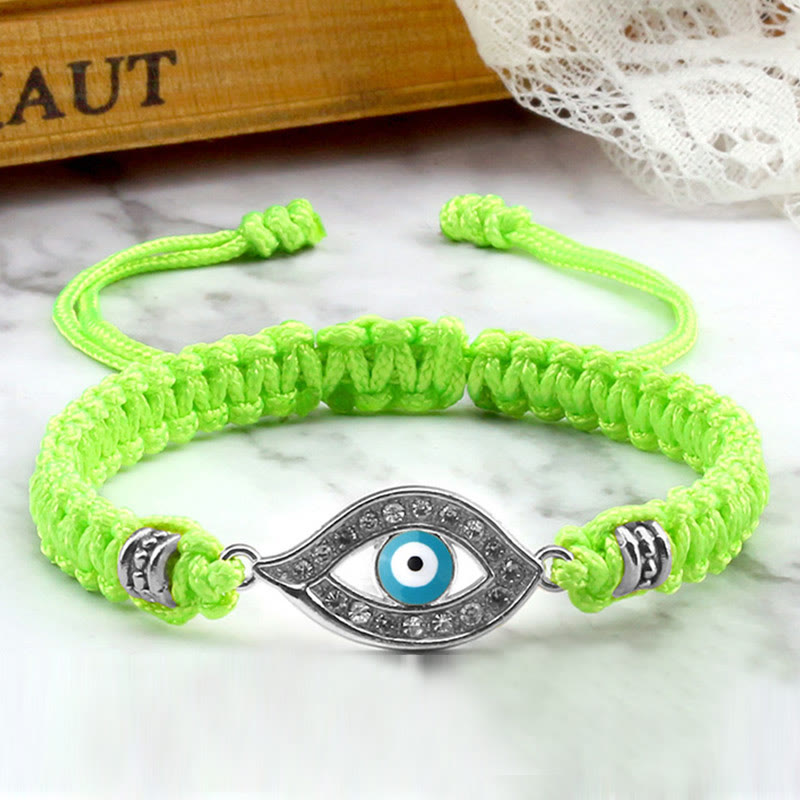 Neon green cord evil eye bracelet with silver blue evil eye crystal charm, marble photo
