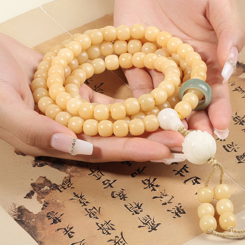 Bodhi Seed Lotus Dzi Bracelet - Cream bodhi beads cupped over Chinese calligraphy parchment, dzi bracelet