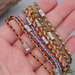 Buddha Head Serenity String Bracelet – Colorful braided bracelets in hand showing woven texture and scale