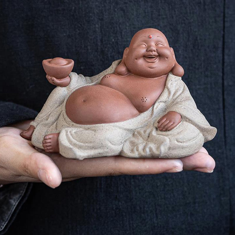 Laughing Buddha Clay Statue – Buddha on red silk cloth with gold coins, ceremonial display setup