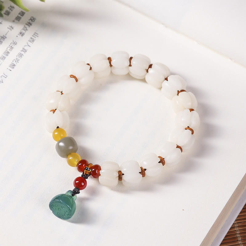 Bodhi Seed Lotus Bead Bracelet - white carved beads on literary page, cultural heritage