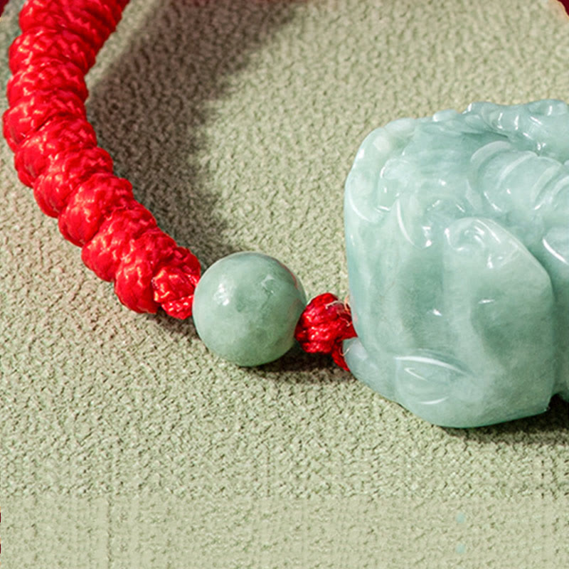 Jade PiXiu Knot Bracelet – Close-up of carved jade PiXiu with red braided cord and jade bead detail