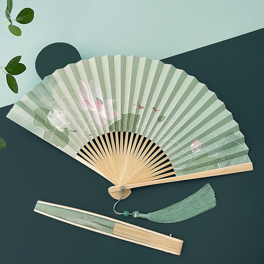Lotus Koi Fish Folding Fan - open and closed with sage tassel on two-tone backdrop, zen elegance