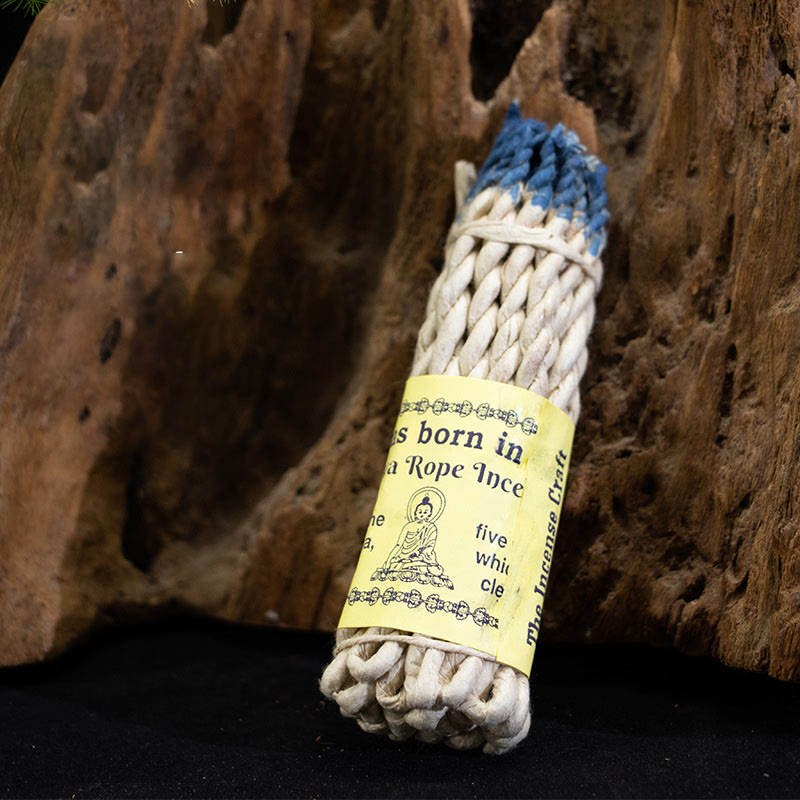 Nepal Rope Incense - blue-tipped bundle on driftwood background, grounding