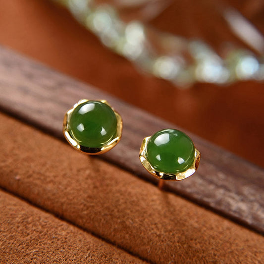 Hetian Cyan Jade Gold Plated Silver Stud Earrings on brown wood