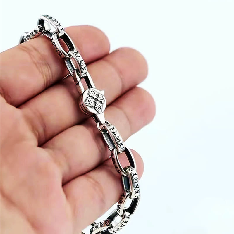 Double Dorje Wisdom Bracelet - Hand-held showing scale and medallion charm, silver mens wrist jewelry