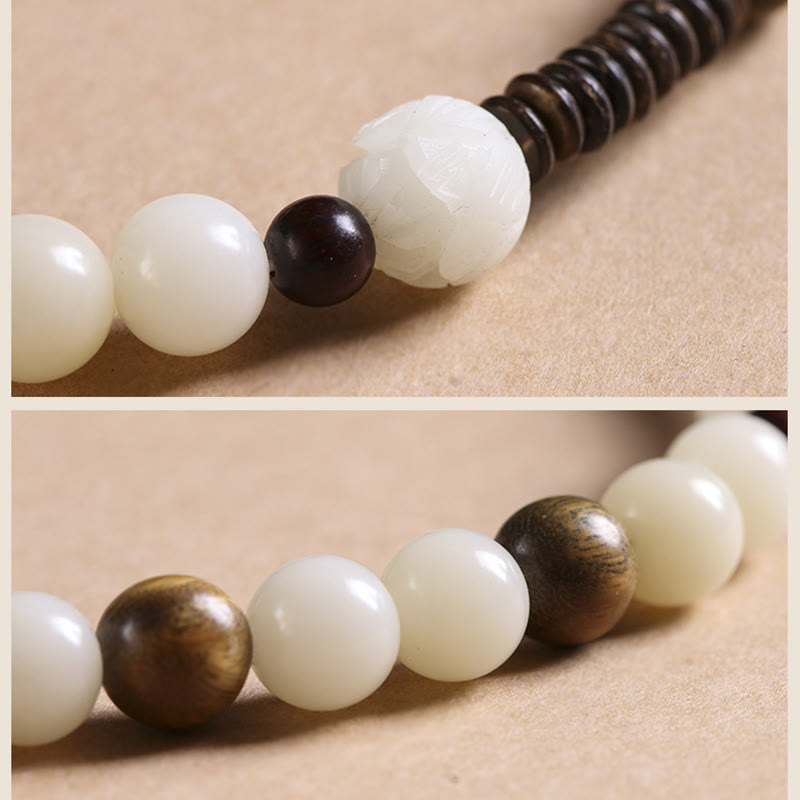 Bodhi Seed Sandalwood Lotus Bracelet - worn on wrist with burgundy sleeve, dual-strand meditation beads
