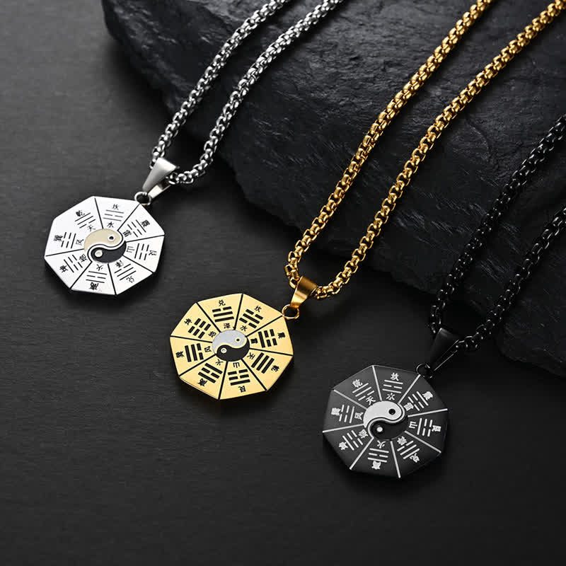 Bagua Yin Yang Titanium Steel Pendant - Three color variants silver gold black on dark stone, bagua pendant