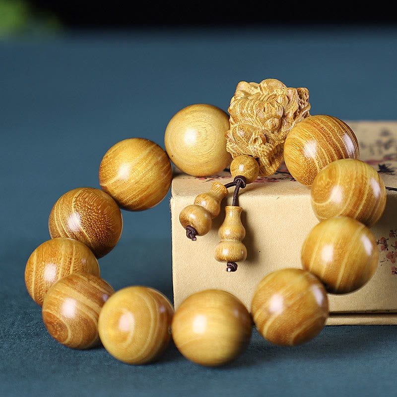 Multi-Wood Dragon Bracelet - Golden wood beads with guardian lion carving and gourd tassel, Strength