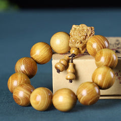 Multi-Wood Dragon Bracelet - Golden wood beads with guardian lion carving and gourd tassel, Strength
