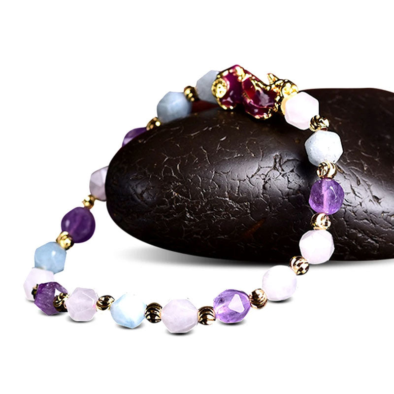 Natural Amethyst Pixiu Bracelet – on black stone side view, white background amethyst pixiu bracelet colorful beads