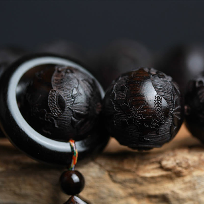 Ebony Wood Yin Yang Gourd Balance Bracelet - side profile with white inlay ring and colorful tassel cord, wooden prayer bead bracelet